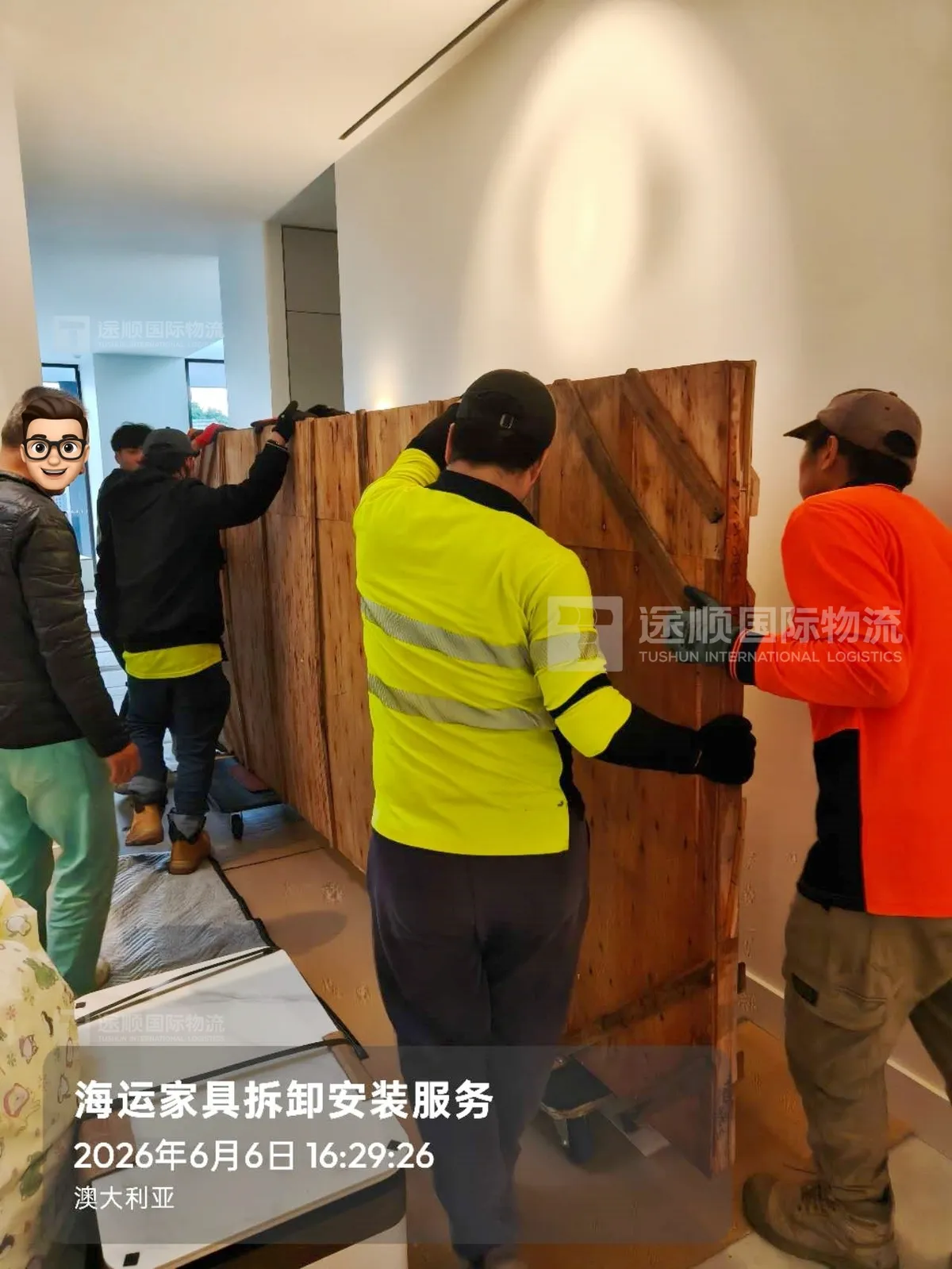 Local delivery crew in hi-vis carrying a cabinet into a house in Australia