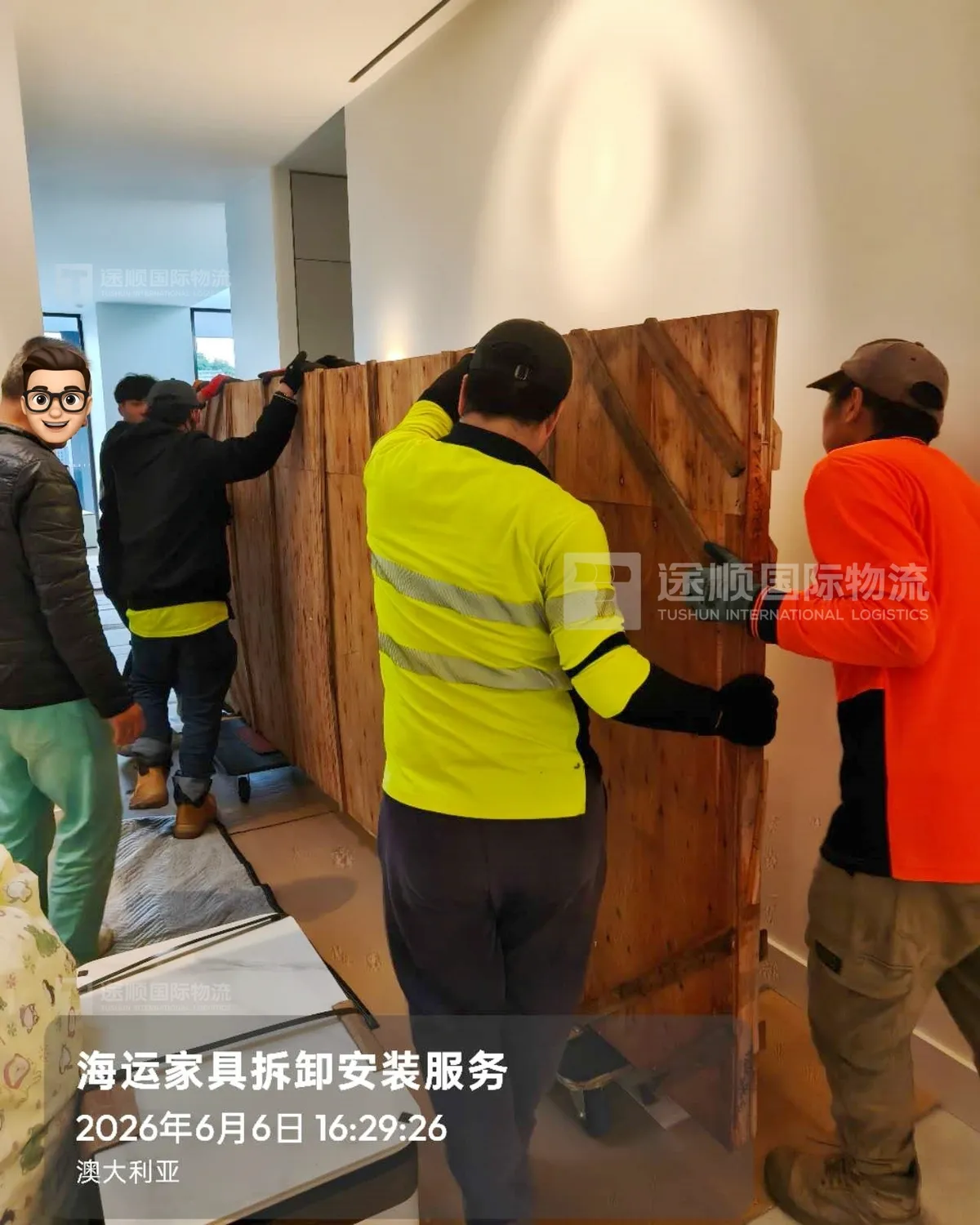 Local delivery crew in hi-vis carrying a cabinet into a house in Australia