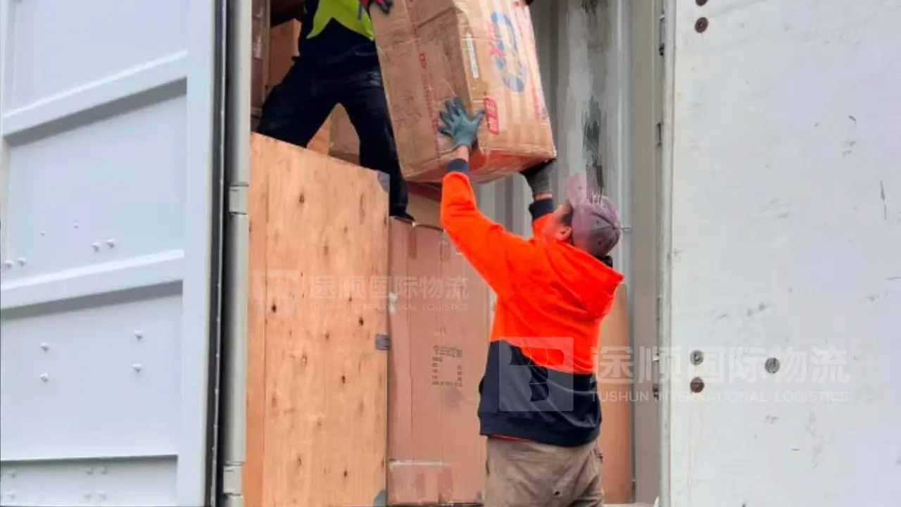 Unloading crates from a container truck in Australia