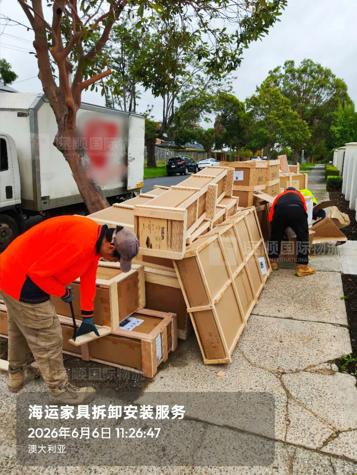 Crates being opened at the kerb outside a house in Australia