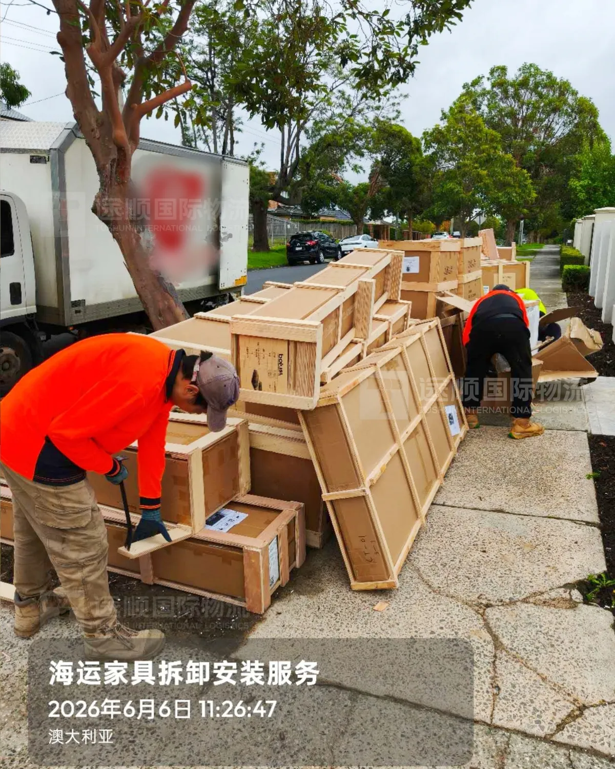 Crates being opened at the kerb outside a house in Australia