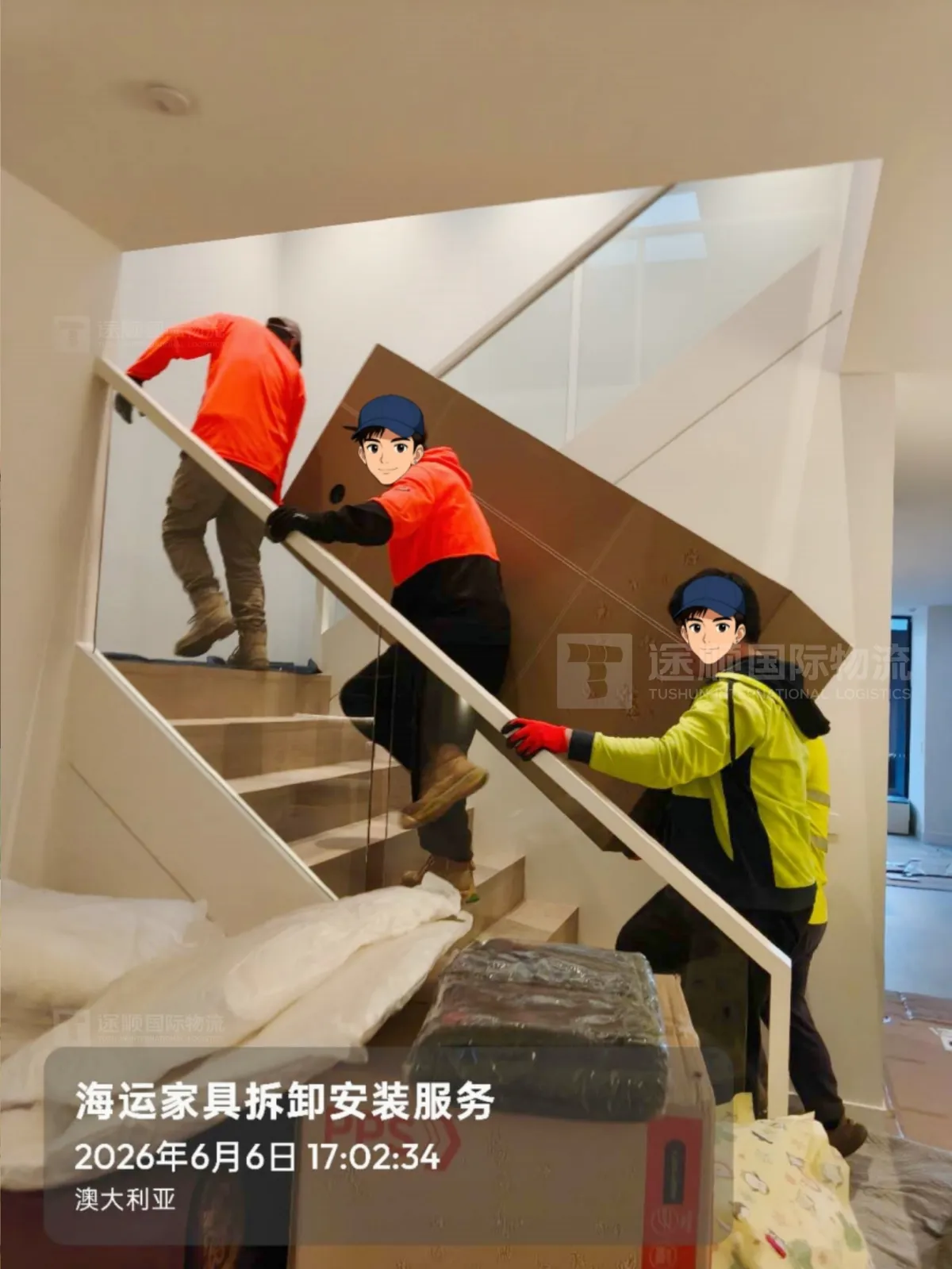 Crew carrying a crated piece up a staircase