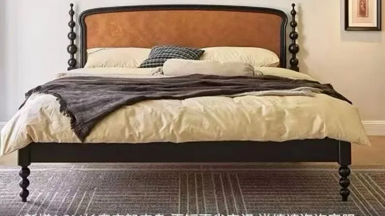 Bed with leather headboard and turned posts