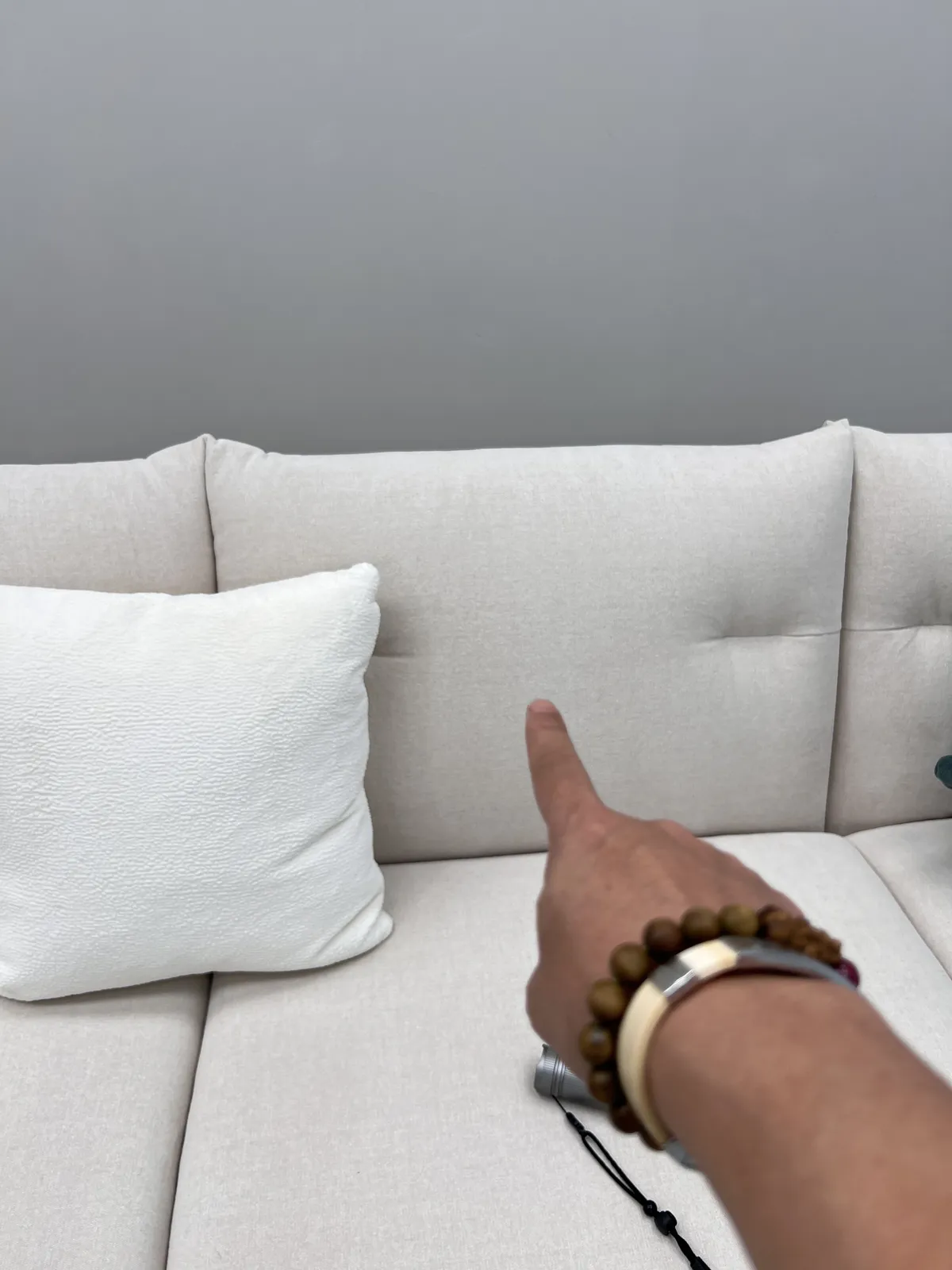 Inspector pointing at a seam on a finished sofa
