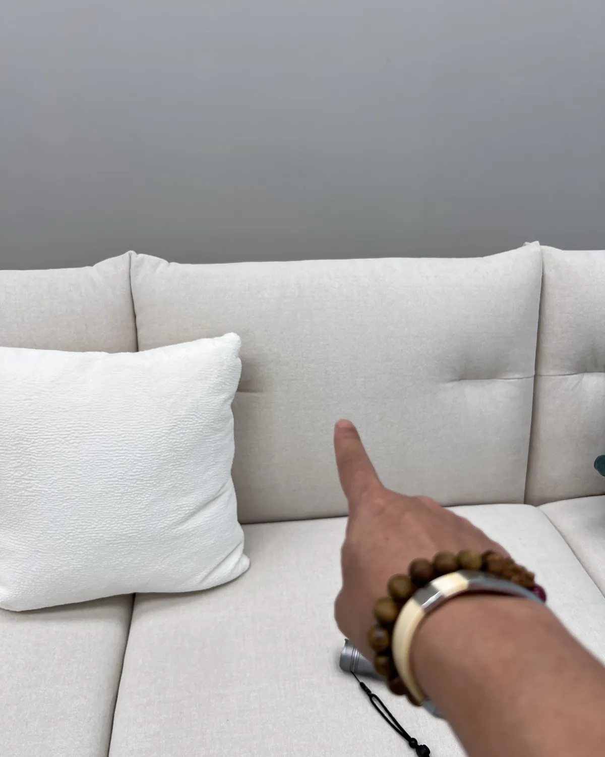 Inspector pointing at a seam on a finished sofa