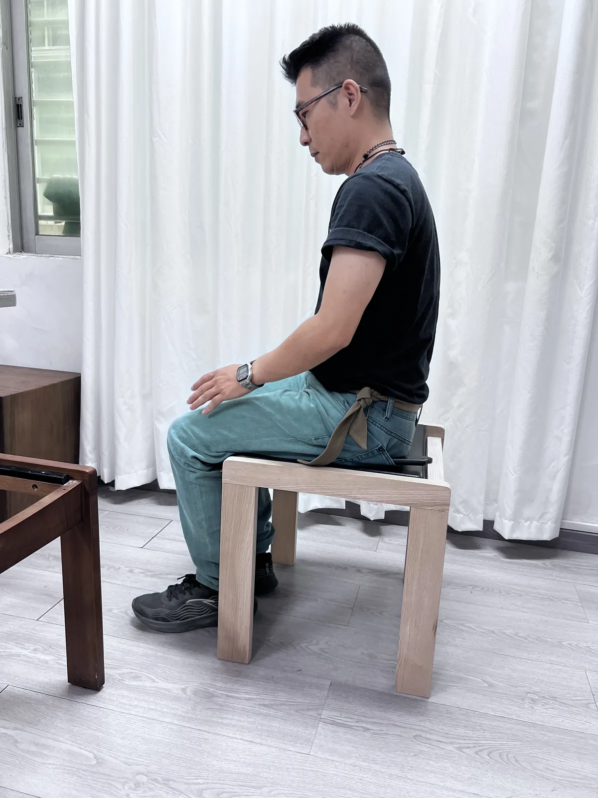 Inspector sitting on a stool to check stability
