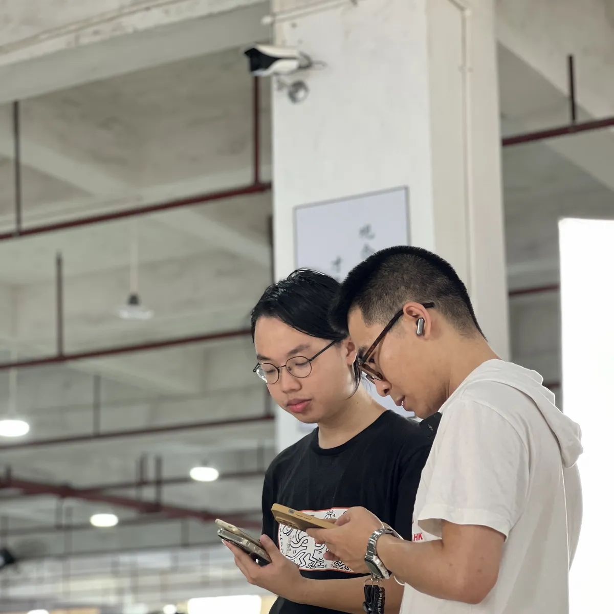 Two inspectors checking a piece against the specification on a tablet