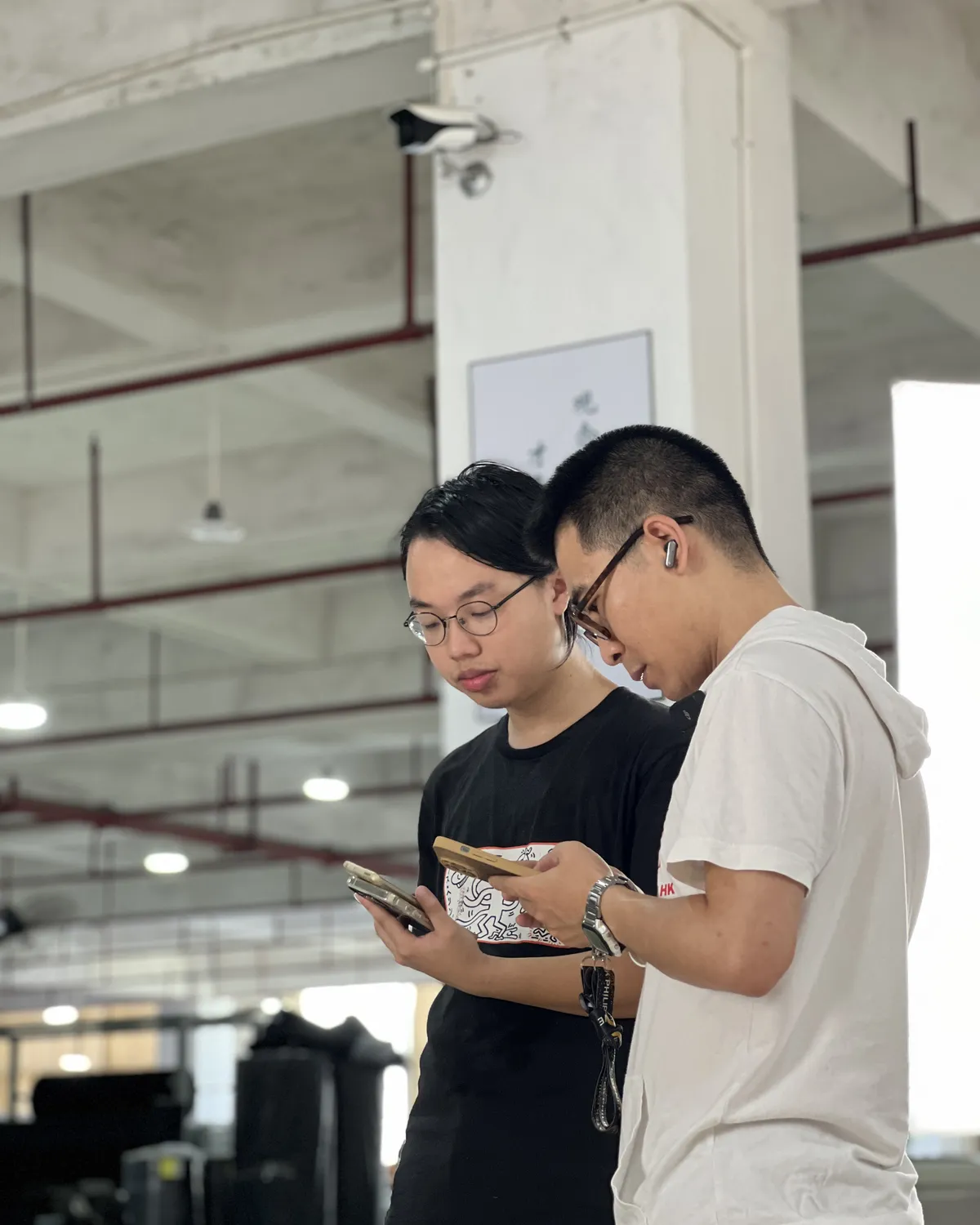 Two inspectors checking a piece against the specification on a tablet