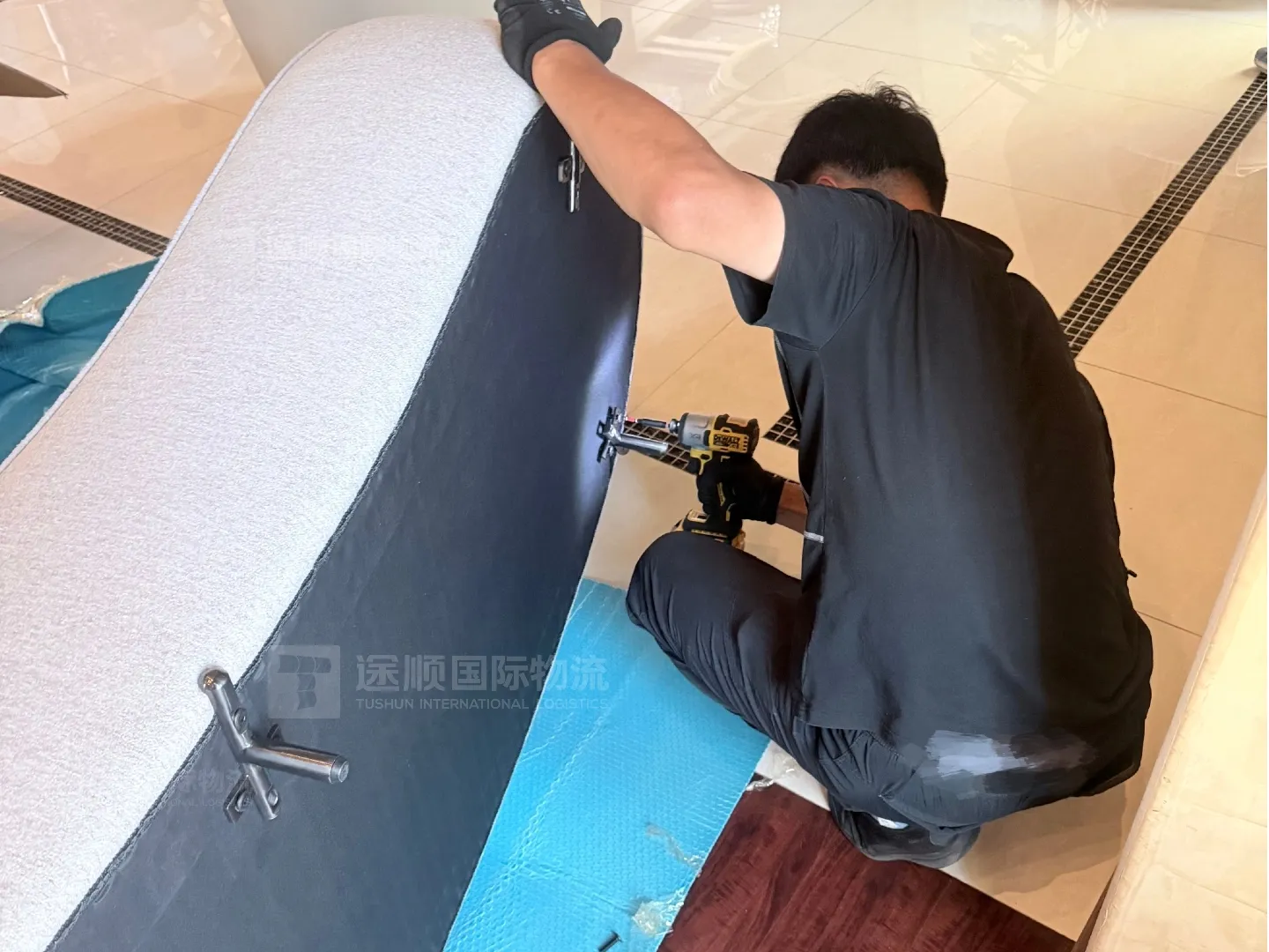 Installer assembling an upholstered bed on site