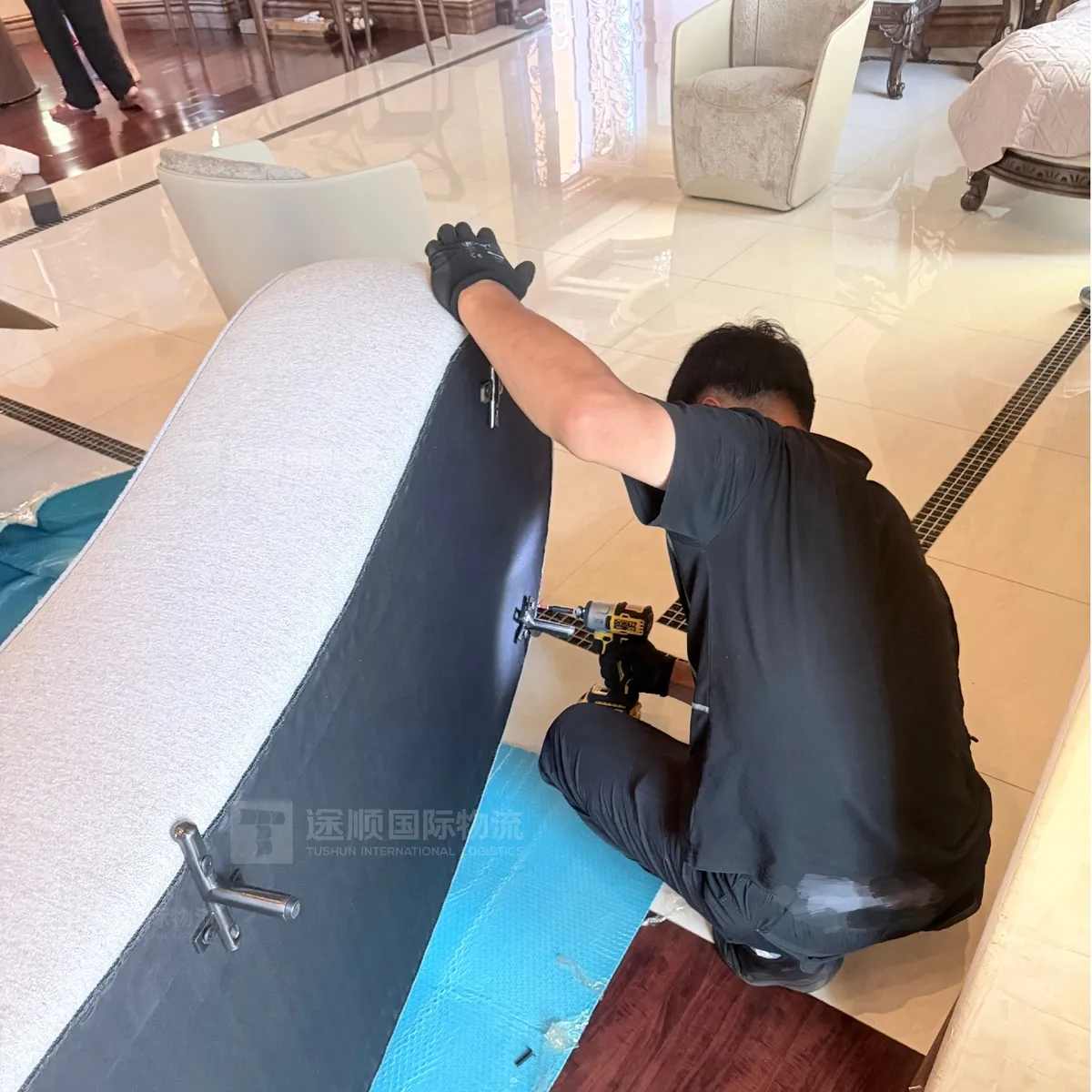 Installer assembling an upholstered bed on site