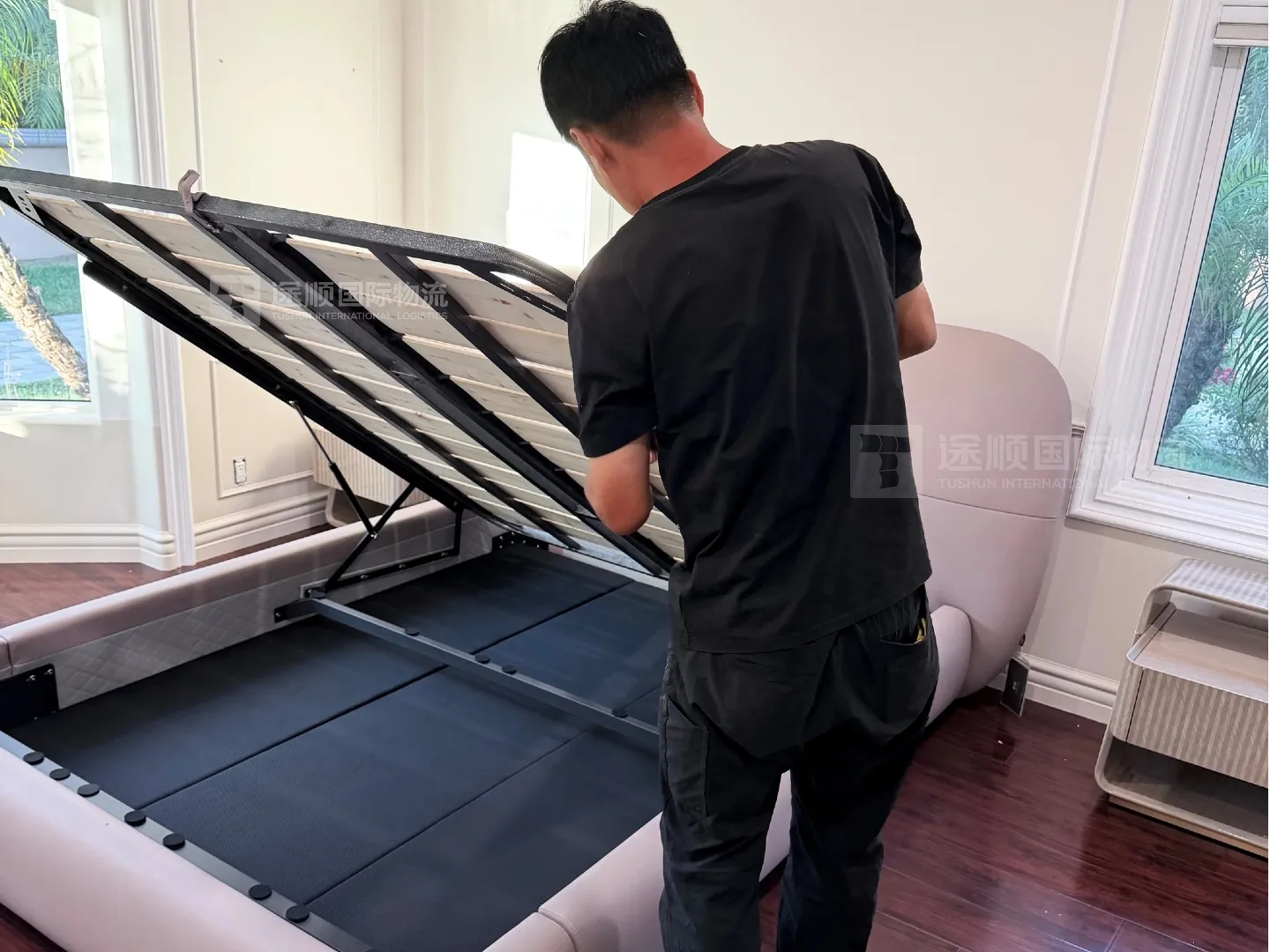 Installer fitting a storage bed base