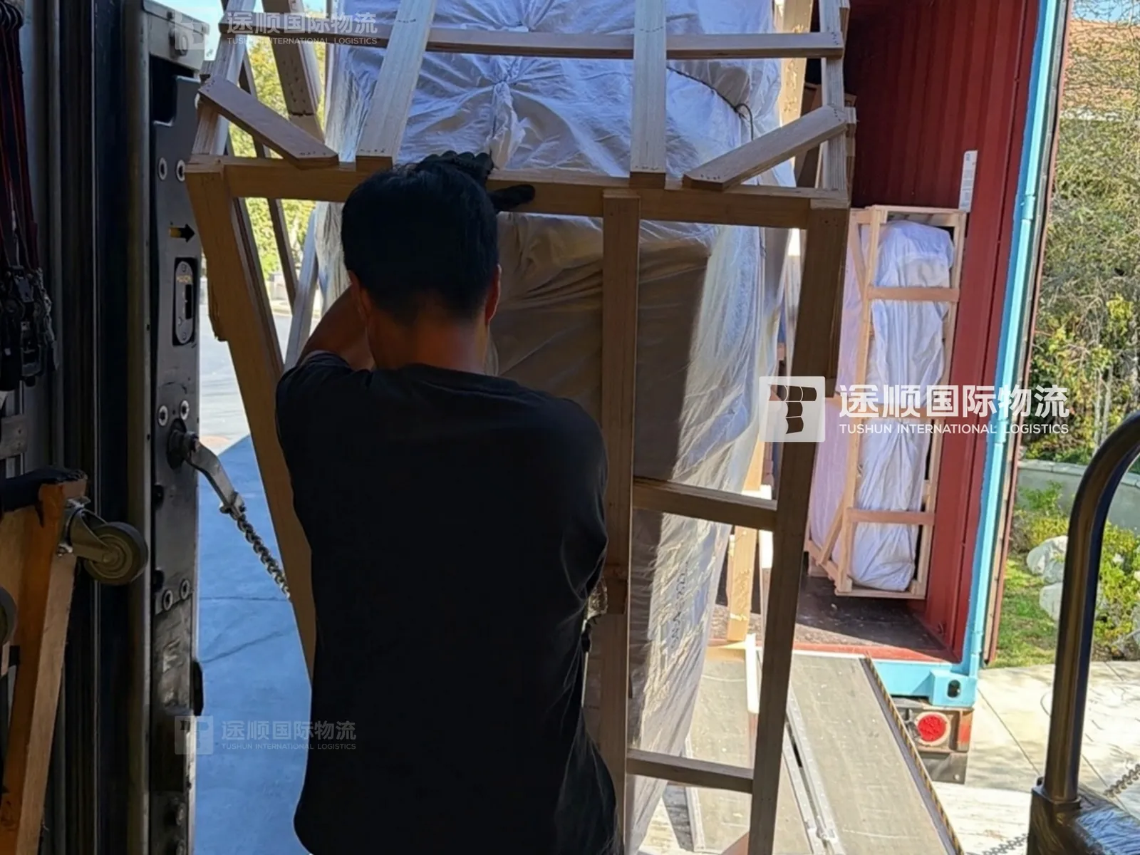Crated piece carried down the container ramp