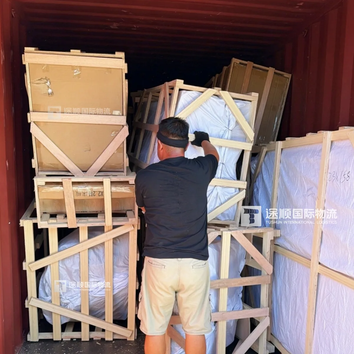 Timber crates inside the shipping container on arrival