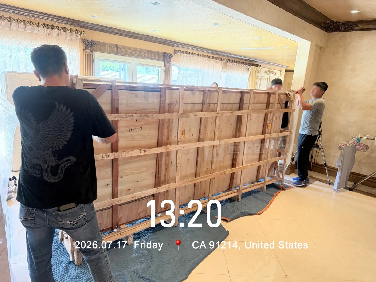 Braced timber crates lined up inside the house before unpacking