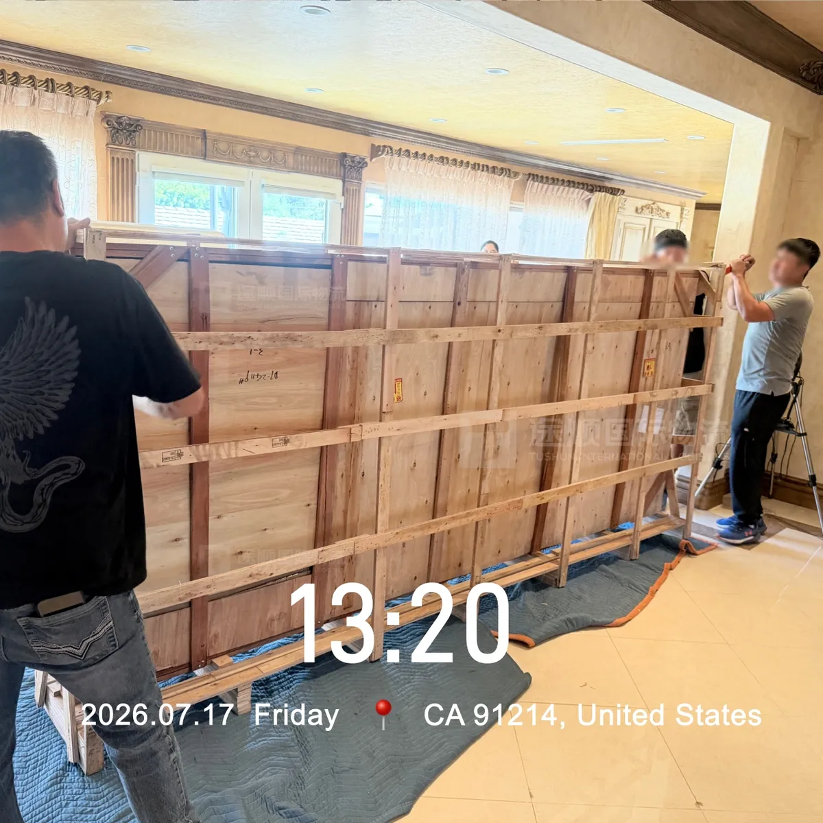 Braced timber crates lined up inside the house before unpacking