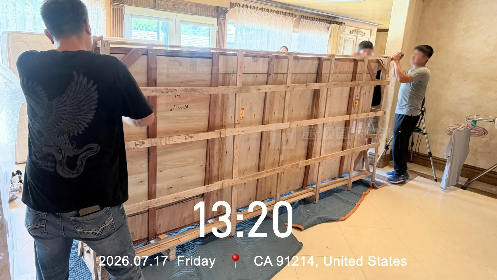 Braced timber crates lined up inside the house before unpacking